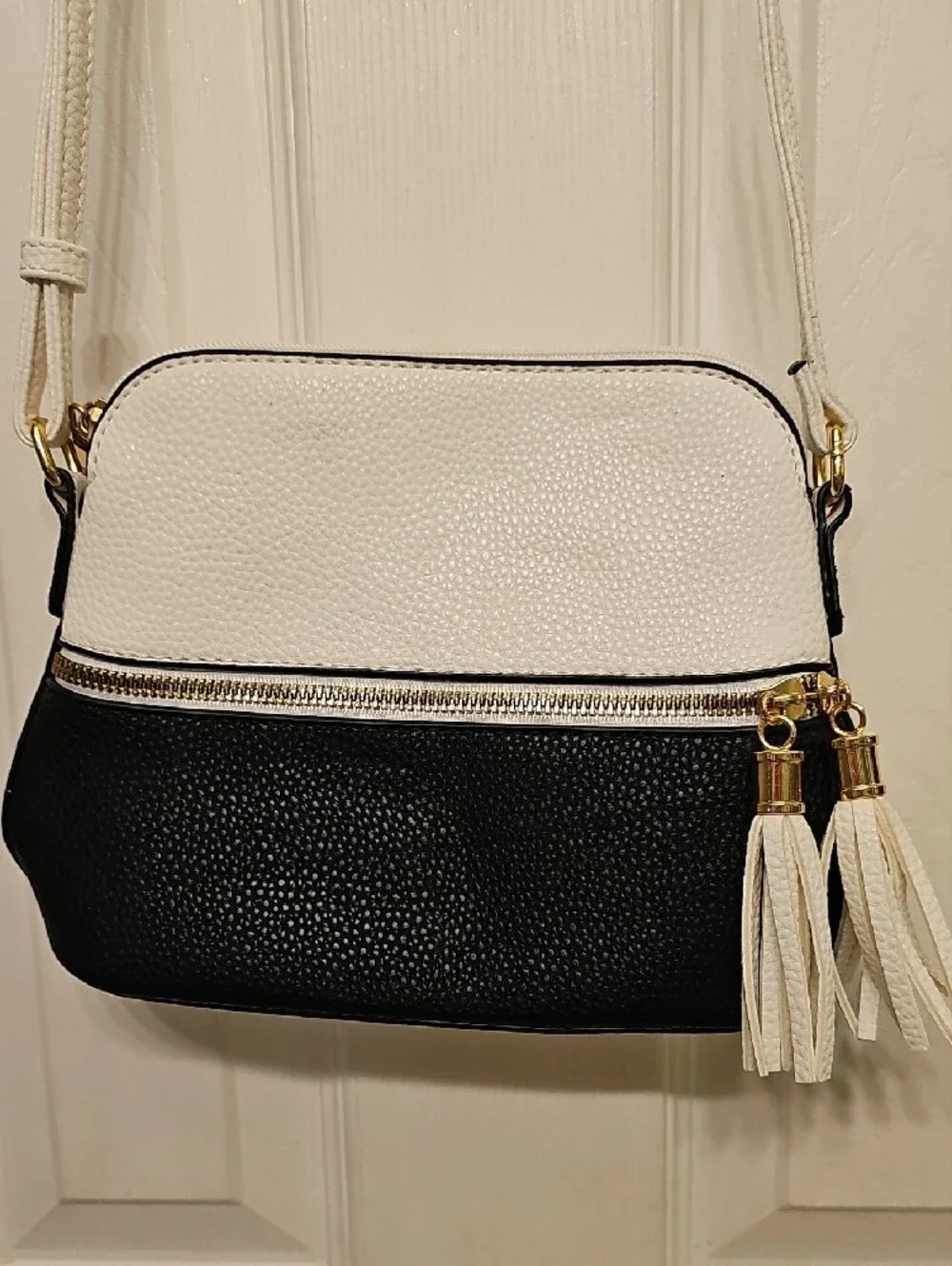 Two-Tone White and Black Crossbody Bag with Tassel Accent